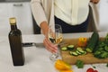 Midsection of senior caucasian woman in modern kitchen, holding glass of wine Royalty Free Stock Photo