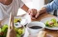 A midsection of senior couple in love indoors at home, having lunch. Royalty Free Stock Photo