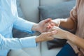 Midsection of therapist holding patient hands