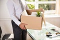 Businessman Holding Belongings In Cardboard Box