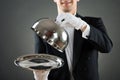 Midsection Of Waiter Holding Cloche Over Empty Tray Royalty Free Stock Photo