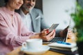 Midsection of an and woman having business meeting in a cafe, using laptop. Royalty Free Stock Photo