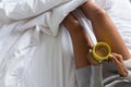 Midsection of woman holding coffee mug on bed Royalty Free Stock Photo