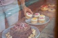 Midsection of woman holding cupcake while standing at table Royalty Free Stock Photo