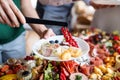 Midsection of a woman putting food on plate on a indoor family birthday party.