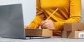 Midsection of a woman writing on a cardboard box. despatch Royalty Free Stock Photo