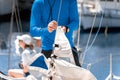 Midsection of a yachtsman checking sail before competition