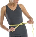 Midsection Young Woman Measuring Her Waistline