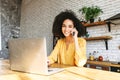 Smiling young girl is using laptop to work online Royalty Free Stock Photo