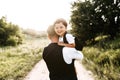 Midshot of a dad with a son on a field road Royalty Free Stock Photo