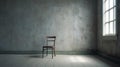 Wooden chair in an empty weathered warehouse room with window