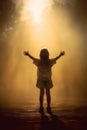 a cute small kid with arms raised. thanking god. praying to jesus. praising the lord. Royalty Free Stock Photo