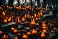 In the midst of pine cones and autumnal brown foliage, cemetery candles are burning. Cemetery. Sadness and memories. Royalty Free Stock Photo