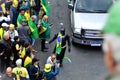 In the midst of the protesters, a batman with the Brazilian flag on his shoulder walks among them.