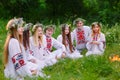 Midsummer. Group of young people of Slavic appearance are sitting around a campfire.