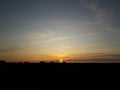 Midsummer sunset with stripe clouds, blue and orange sky