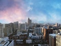 Midtown Atlanta drone footage of skyline and cityscape during the day with colorful pink and blue clouds.