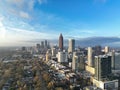 Midtown Atlanta drone picture of skyline and cityscape during the day with sun shinning through clouds