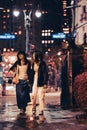 Midtown Manhattan street scene viewed at night with people, cars and building