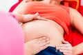 Midwife exanimating belly of pregnant woman manually Royalty Free Stock Photo