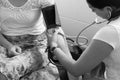 Midwife measures blood pressure of pregnant woman Royalty Free Stock Photo