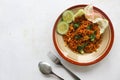 mie tek tek or fried noodle made with egg noodles with chicken, cabbage, mustard greens, meatballs, scrambled eggs. indonesian. Royalty Free Stock Photo