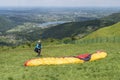 Miedzybrodzie, Silesia, Poland - 29 May 2022: Paraglider preparing to start. Colorful kite lying on the grass. Beautiful, mountain