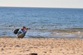 Miedzyzdroje, Poland, November 2018. professional photographer taking pictures on the beach