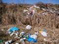 Construction and household waste near roadside, conceptual human negligence image.