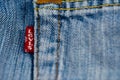 Red Levi Strauss logo on blue jeans close up macro shot. Royalty Free Stock Photo