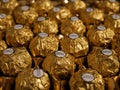 Group of golden Ferrero Rocher chocolates close up shot.