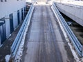 Asphalt road leads to the underground parking lot near local mall.