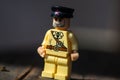 Lego army officer close up shot on dark wooden surface.