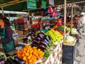 People buying fresh fruits and vegetables at the local market.