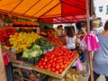 People buying fresh fruits and vegetables at the local market.