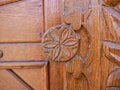 Detailed hand carved flower on traditional hungarian oak wood gate pylon . Royalty Free Stock Photo