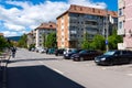 Parking cars near old apartment buidings on a sunny day. Royalty Free Stock Photo