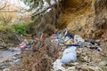 Cleen little creek contaminated with household waste, conceptual human negligence image. Royalty Free Stock Photo