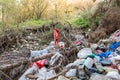 Cleen little creek contaminated with household waste, conceptual human negligence image. Royalty Free Stock Photo