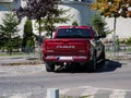 Back view of a red parked Dodge Ram pickup truck on the streets.