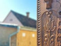 Detailed hand carved tulip on traditional hungarian oak wood gate pylon . Royalty Free Stock Photo