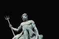 The mighty god of sea and oceans Neptune Poseidon The ancient statue against black background Royalty Free Stock Photo