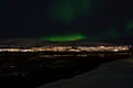 Mighty northern light dancing over snowy mountain peak in northern norway on the whale island