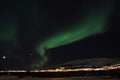 Mighty northern light dancing over snowy mountain peak in northern norway on the whale island