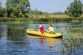 Family kayaking on the river. Little boy with his mothe