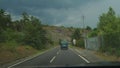 Mignano, Italy - July 29th 2022 Woman driving suv in a mountain hill road while raining