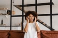 Migraine is a strong headache of african american woman. Overstressed woman touches her head because of pain. Depression