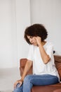 Migraine is a strong headache of african american woman. Overstressed woman touches her head because of pain. Depression