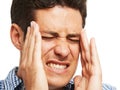 This migraine is unbearable. A young man holding his head as a result of a splitting headache.