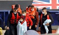 Migrant families with children arrive at the port of Dover after being rescued at sea.